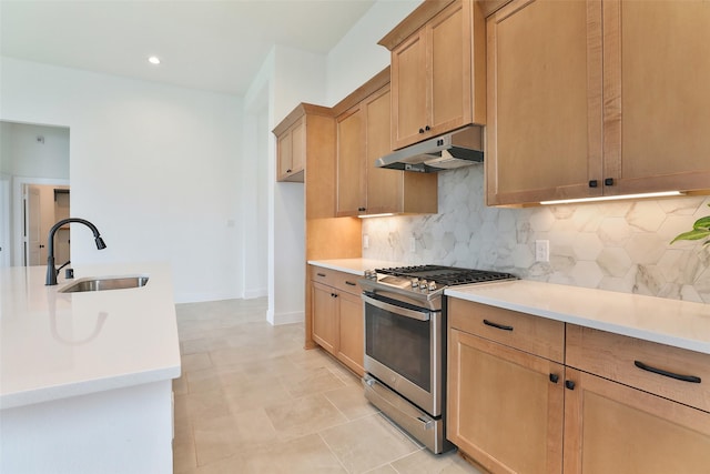 24526 Bluestar Blossom Trl, Katy, TX 77493 - kitchen with stainless steel range with gas cooktop, under cabinet range hood, decorative backsplash, light countertops, and recessed lighting
