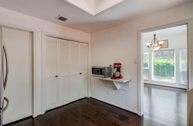 11711 Memorial Dr Unit 635, Houston, TX 77024 - hallway featuring a chandelier and dark wood finished floors