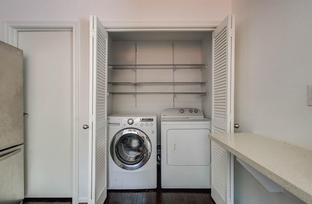 11711 Memorial Dr Unit 635, Houston, TX 77024 - washroom with washing machine and clothes dryer and dark wood-style flooring