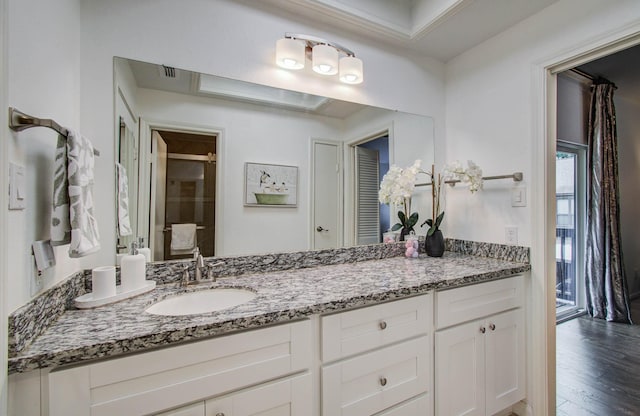 11711 Memorial Dr Unit 635, Houston, TX 77024 - full bathroom featuring vanity, wood finished floors, and an enclosed shower