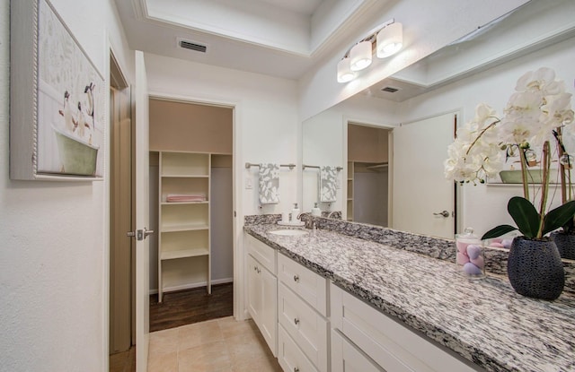11711 Memorial Dr Unit 635, Houston, TX 77024 - bathroom with vanity, a spacious closet, and tile patterned floors