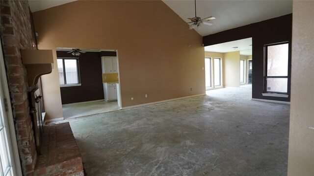 6303 Greenway Forest Ln, Houston, TX 77088 - unfurnished living room with ceiling fan, high vaulted ceiling, healthy amount of natural light, and concrete floors