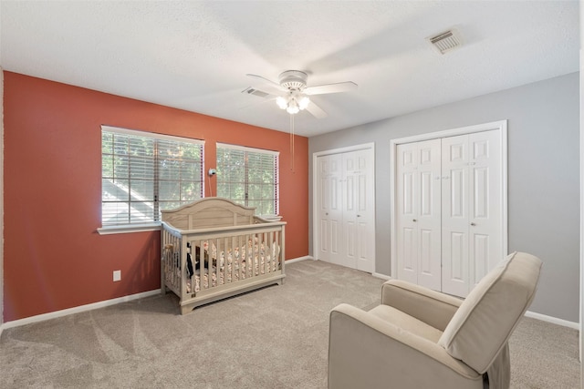 902 Mulberry Ridge Way, Houston, TX 77062 - carpeted bedroom featuring two closets and ceiling fan