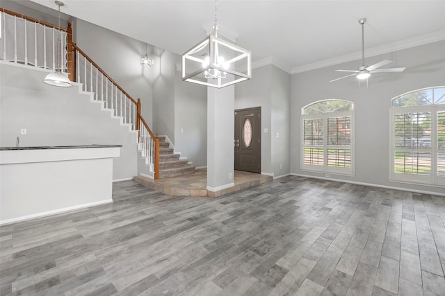 902 Mulberry Ridge Way, Houston, TX 77062 - entryway featuring wood finished floors, stairs, a ceiling fan, ornamental molding, and a high ceiling