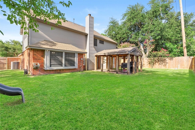 902 Mulberry Ridge Way, Houston, TX 77062 - back of house featuring a gazebo, brick siding, a chimney, and a fenced backyard