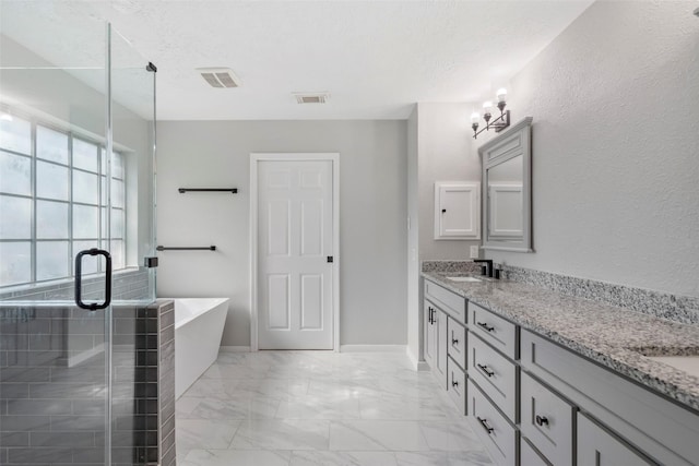 902 Mulberry Ridge Way, Houston, TX 77062 - full bathroom featuring double vanity, a soaking tub, a shower stall, marble finish flooring, and a textured ceiling