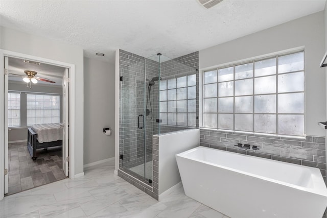 902 Mulberry Ridge Way, Houston, TX 77062 - bathroom featuring a freestanding tub, marble look tile flooring, a stall shower, a ceiling fan, and a textured ceiling