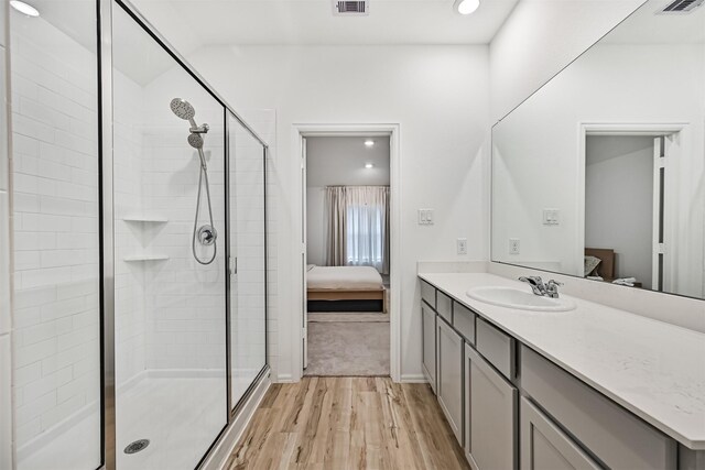 19911 Paros Island Dr, Hockley, TX 77447 - ensuite bathroom with wood finished floors, a shower stall, vanity, and recessed lighting