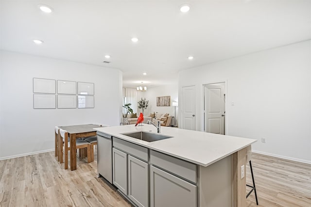 19911 Paros Island Dr, Hockley, TX 77447 - kitchen featuring gray cabinets, stainless steel dishwasher, a center island with sink, light wood-type flooring, and recessed lighting