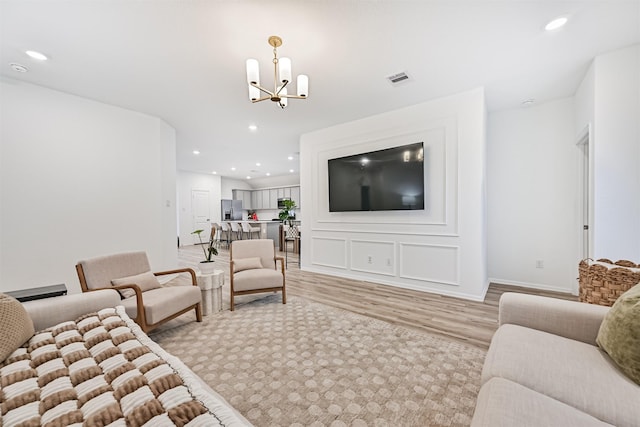19911 Paros Island Dr, Hockley, TX 77447 - living area featuring a chandelier, light wood-type flooring, and recessed lighting