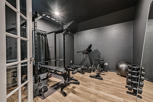 19911 Paros Island Dr, Hockley, TX 77447 - exercise area with wood finished floors and a textured wall