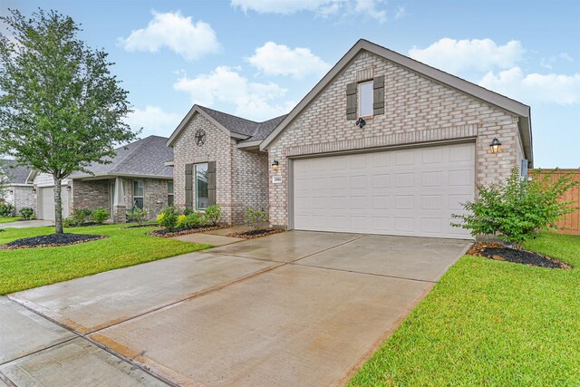 19911 Paros Island Dr, Hockley, TX 77447 - view of front of house featuring brick siding, driveway, a front lawn, a garage, and roof with shingles