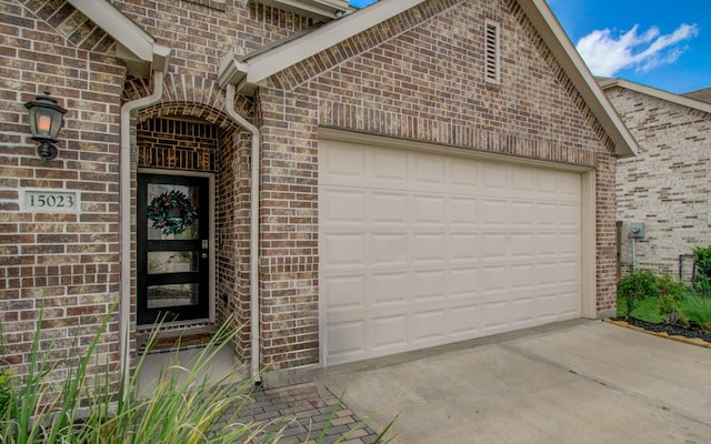 15023 Eves Necklace Ct, Cypress, TX 77433 - doorway to property featuring brick siding, driveway, and an attached garage