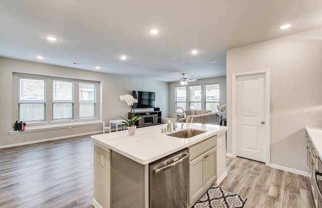 15023 Eves Necklace Ct, Cypress, TX 77433 - kitchen with stainless steel dishwasher, open floor plan, light wood-style flooring, light countertops, and ceiling fan