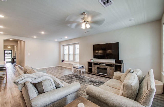 15023 Eves Necklace Ct, Cypress, TX 77433 - living area featuring arched walkways, ceiling fan, wood finished floors, recessed lighting, and a fireplace