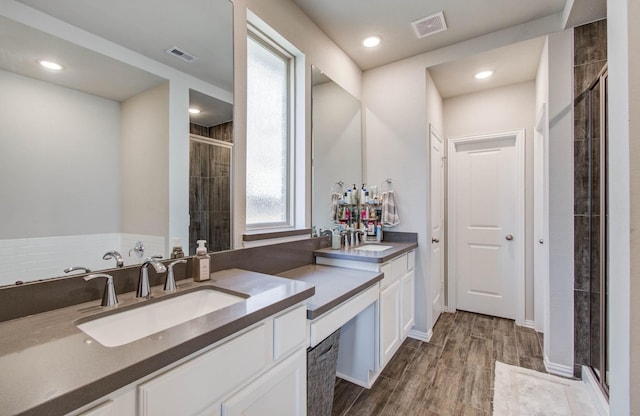 15023 Eves Necklace Ct, Cypress, TX 77433 - bathroom featuring a stall shower, double vanity, wood finished floors, and recessed lighting