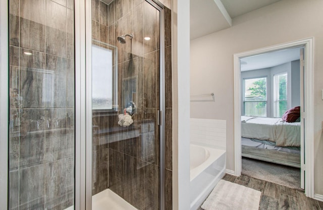 15023 Eves Necklace Ct, Cypress, TX 77433 - ensuite bathroom featuring a garden tub, a shower stall, and wood finished floors