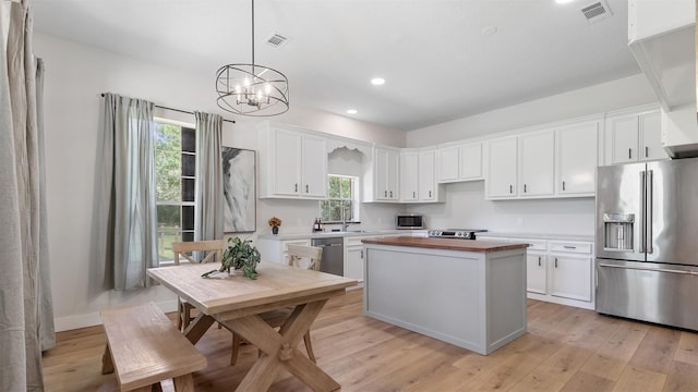 27938 Deer Run St, Montgomery, TX 77356 - kitchen featuring stainless steel appliances, a center island, recessed lighting, white cabinetry, and a chandelier