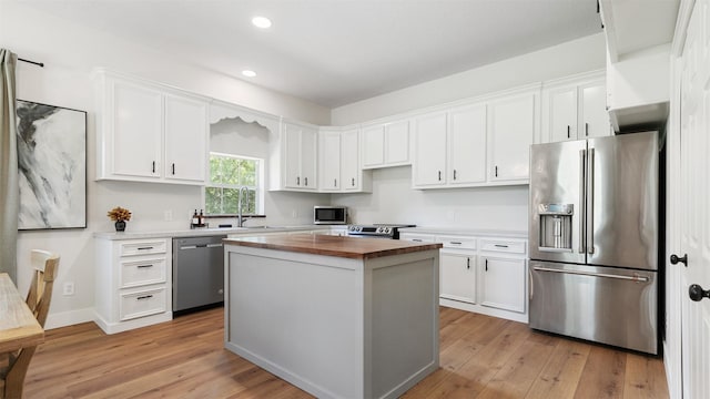 27938 Deer Run St, Montgomery, TX 77356 - kitchen with stainless steel appliances, wood counters, white cabinets, recessed lighting, and light wood-style flooring