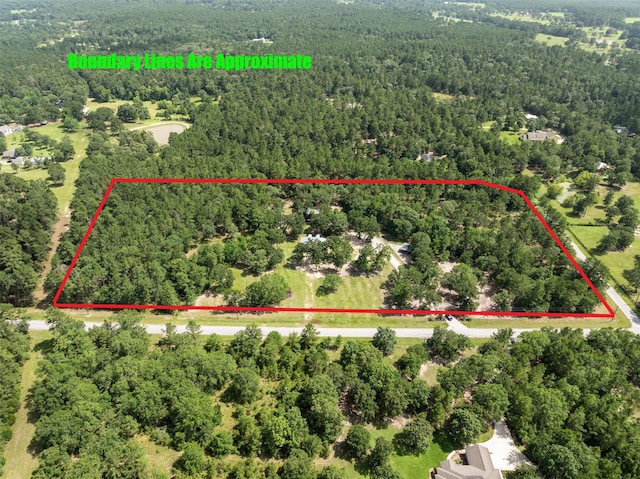 27938 Deer Run St, Montgomery, TX 77356 - aerial view of property's location featuring a heavily wooded area and property parcel outlined