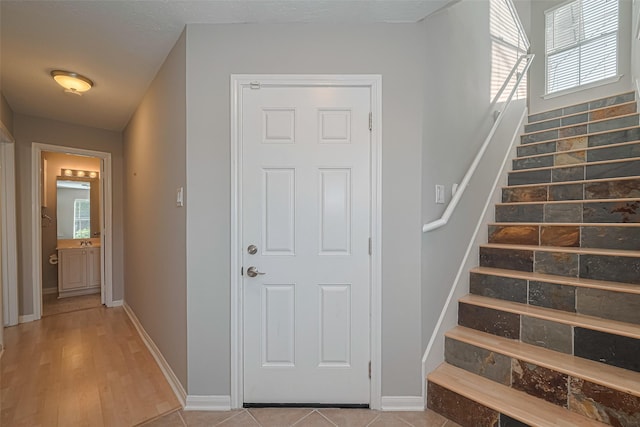 1101 Saulnier St, Houston, TX 77019 - stairway with plenty of natural light and wood finished floors