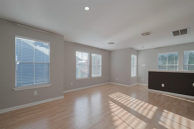 1101 Saulnier St, Houston, TX 77019 - empty room with light wood-style flooring and recessed lighting