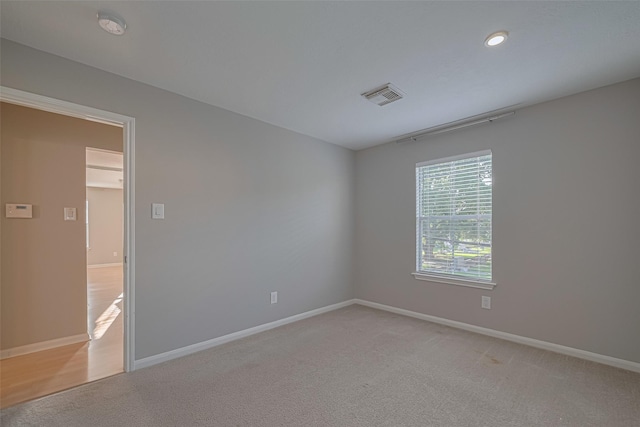 1101 Saulnier St, Houston, TX 77019 - empty room featuring light colored carpet and recessed lighting