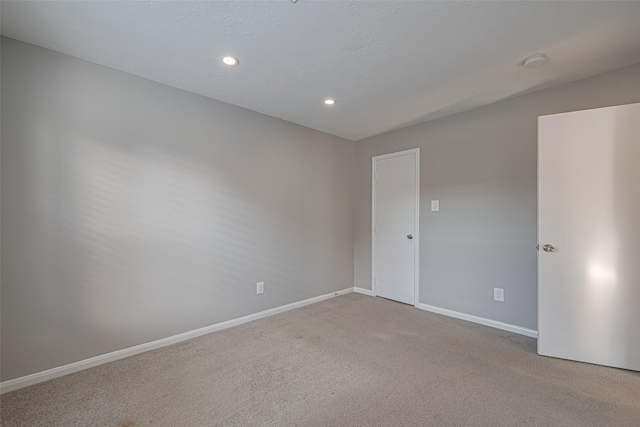 1101 Saulnier St, Houston, TX 77019 - empty room with a smoke detector, carpet, and recessed lighting