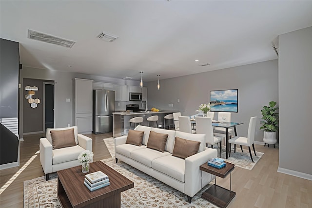 1101 Saulnier St, Houston, TX 77019 - living room with light wood finished floors and recessed lighting