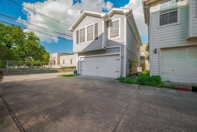 1101 Saulnier St, Houston, TX 77019 - view of property exterior featuring a garage and concrete driveway