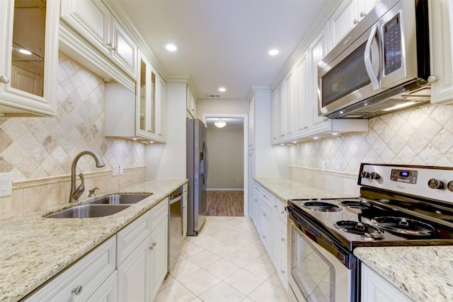 14436 Misty Meadow Ln, Houston, TX 77079 - kitchen with stainless steel appliances, light tile patterned floors, backsplash, white cabinets, and recessed lighting