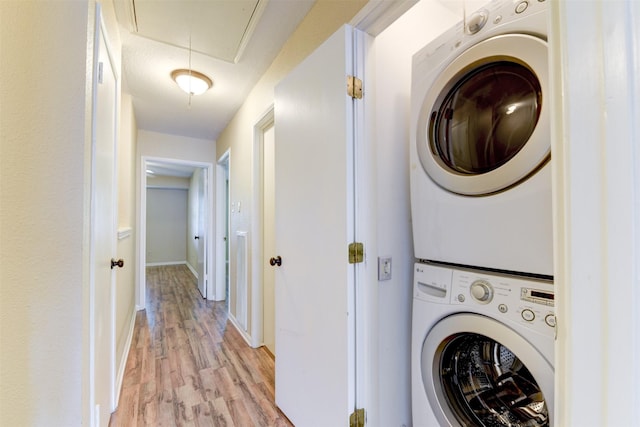 14436 Misty Meadow Ln, Houston, TX 77079 - laundry room with stacked washer / dryer, attic access, and light wood finished floors