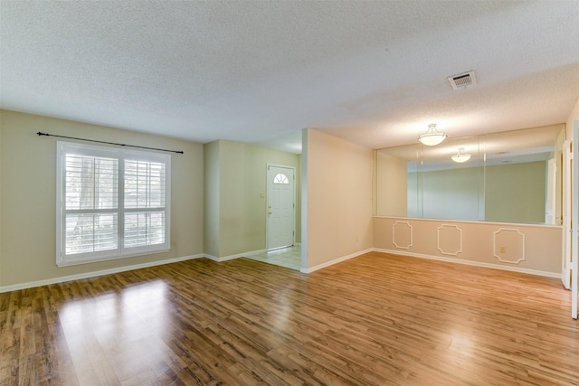 14436 Misty Meadow Ln, Houston, TX 77079 - empty room featuring a textured ceiling and wood finished floors