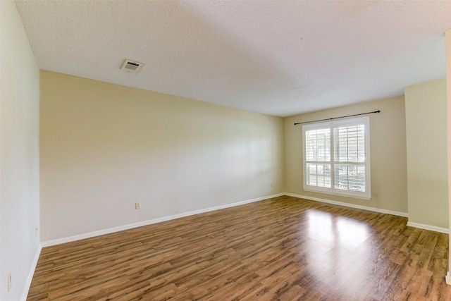 14436 Misty Meadow Ln, Houston, TX 77079 - empty room featuring wood finished floors and a textured ceiling