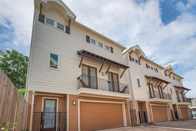 5307 Nett St Unit C, Houston, TX 77007 - view of front of home featuring an attached garage, a balcony, french doors, and driveway