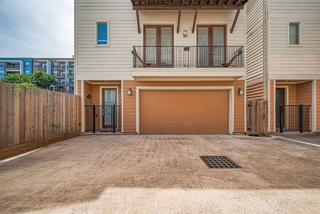5307 Nett St Unit C, Houston, TX 77007 - multi unit property featuring concrete driveway, an attached garage, a balcony, and a gate