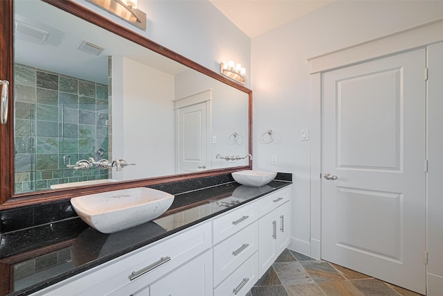 5307 Nett St Unit C, Houston, TX 77007 - full bathroom with double vanity, stone finish floors, and tiled shower
