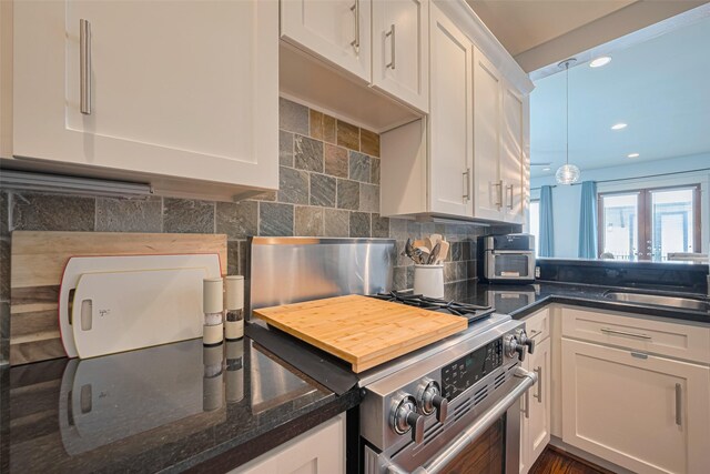 5307 Nett St Unit C, Houston, TX 77007 - kitchen featuring gas range, white cabinetry, backsplash, recessed lighting, and dark stone counters