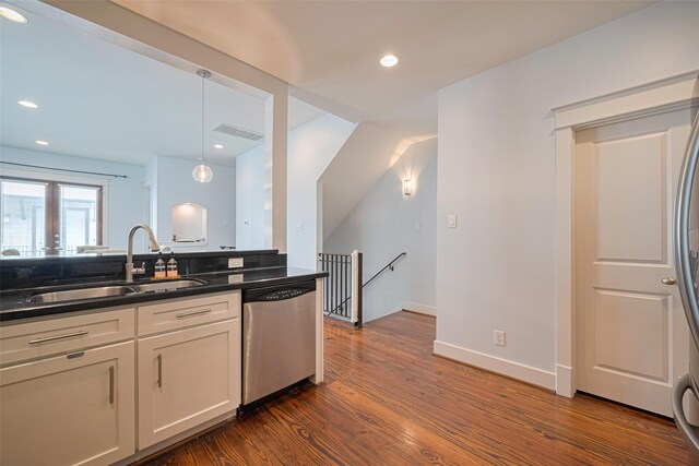 5307 Nett St Unit C, Houston, TX 77007 - kitchen featuring stainless steel dishwasher, dark wood finished floors, hanging light fixtures, white cabinets, and recessed lighting