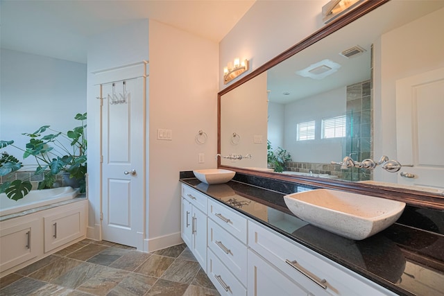 5307 Nett St Unit C, Houston, TX 77007 - full bath with double vanity, a garden tub, and stone finish floors