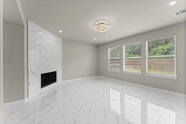 7347 Liberty Ridge Ln, Houston, TX 77049 - unfurnished living room featuring light marble finish flooring, recessed lighting, and a fireplace