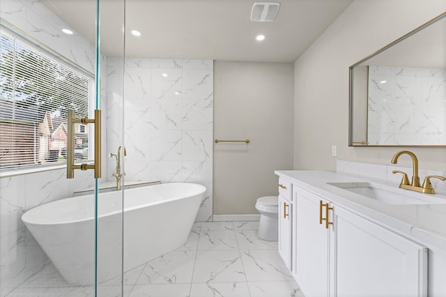 7347 Liberty Ridge Ln, Houston, TX 77049 - bathroom featuring marble finish floors, vanity, a soaking tub, recessed lighting, and tile walls
