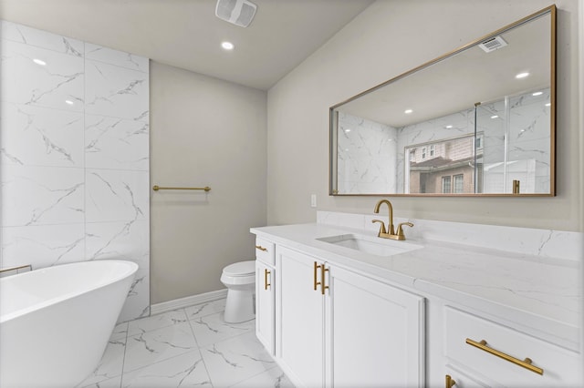 7347 Liberty Ridge Ln, Houston, TX 77049 - bathroom with marble finish flooring, a freestanding tub, vanity, recessed lighting, and a marble finish shower