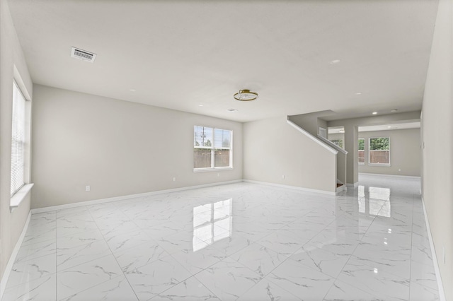 7347 Liberty Ridge Ln, Houston, TX 77049 - empty room with marble finish flooring, healthy amount of natural light, and stairway