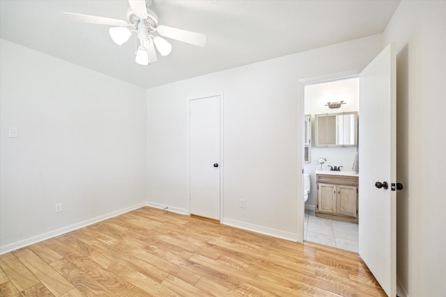 3006 Hartwick Rd, Houston, TX 77093 - unfurnished bedroom with light wood-type flooring, ensuite bathroom, and a ceiling fan