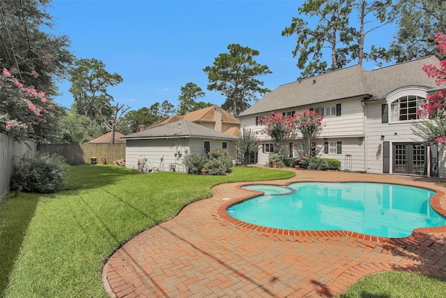 1907 Wagon Gap Trl, Houston, TX 77090 - view of pool featuring a fenced backyard, french doors, a pool with connected hot tub, and a patio area