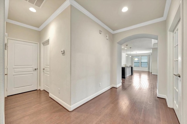 716 Saturnia Ln, League City, TX 77573 - corridor with wood finished floors, arched walkways, crown molding, and recessed lighting