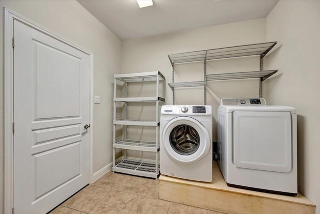 716 Saturnia Ln, League City, TX 77573 - laundry area with washer and dryer and tile patterned floors