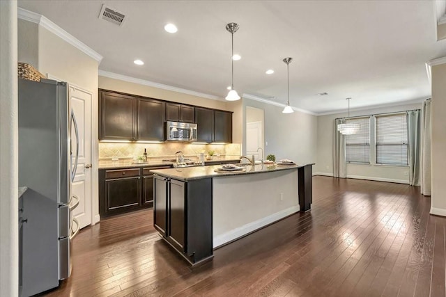 716 Saturnia Ln, League City, TX 77573 - kitchen featuring stainless steel appliances, dark wood-type flooring, decorative backsplash, dark brown cabinetry, and recessed lighting
