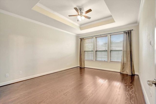 716 Saturnia Ln, League City, TX 77573 - spare room with a tray ceiling, dark wood finished floors, a ceiling fan, and ornamental molding